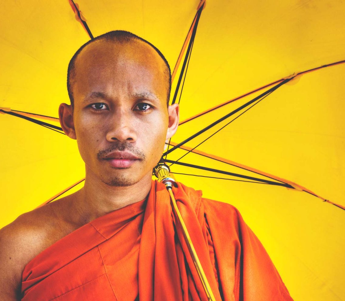 buddhist-monk-holding-umbrella-ceremony-concept-PGEF86M.jpg